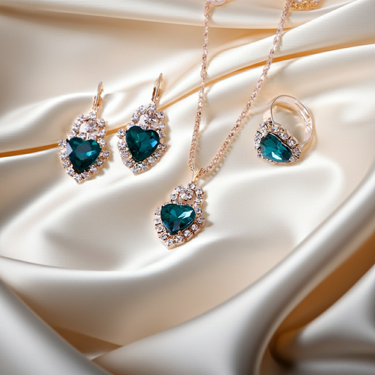 Stylish 3Sixty5 rhinestone jewelry set featuring heart-shaped earrings, necklace, and ring on satin fabric