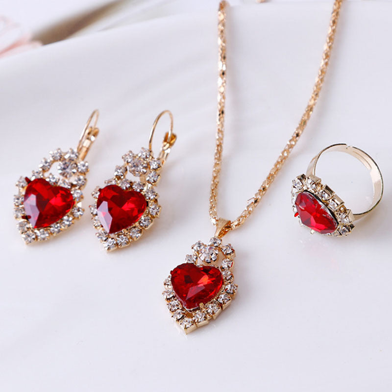 Stylish 3Sixty5 rhinestone jewelry set featuring red heart gemstones in a gold-tone design