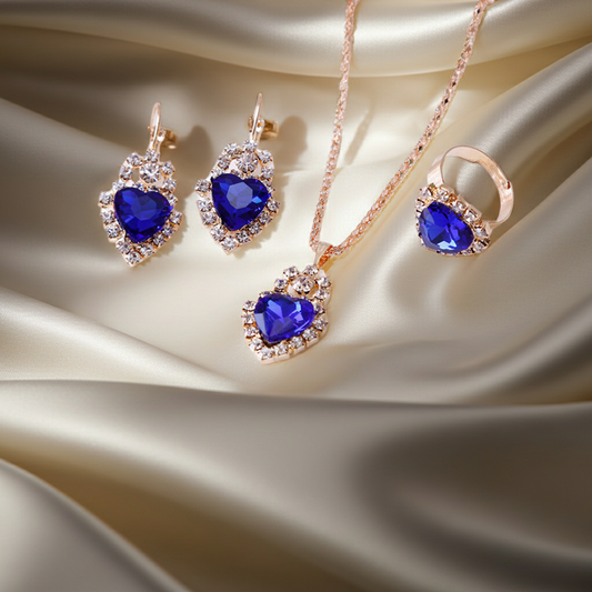Stylish 3Sixty5 rhinestone jewelry set featuring heart-shaped earrings, necklace, and ring with blue gemstones