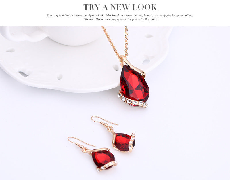 Elegant royal dewdrop jewelry set featuring a red pendant necklace and matching earrings