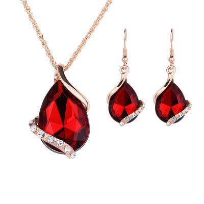 Elegant royal dewdrop jewelry set featuring a red crystal pendant necklace and matching earrings