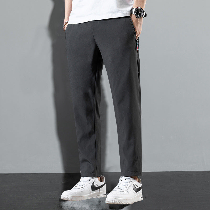 Stylish lightweight trousers in dark gray with a tapered fit and side pockets for casual wear