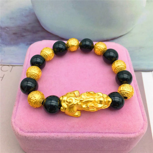 Stylish 3Sixty5 trendy gold bracelet with black beads and a lion charm for a fashionable look