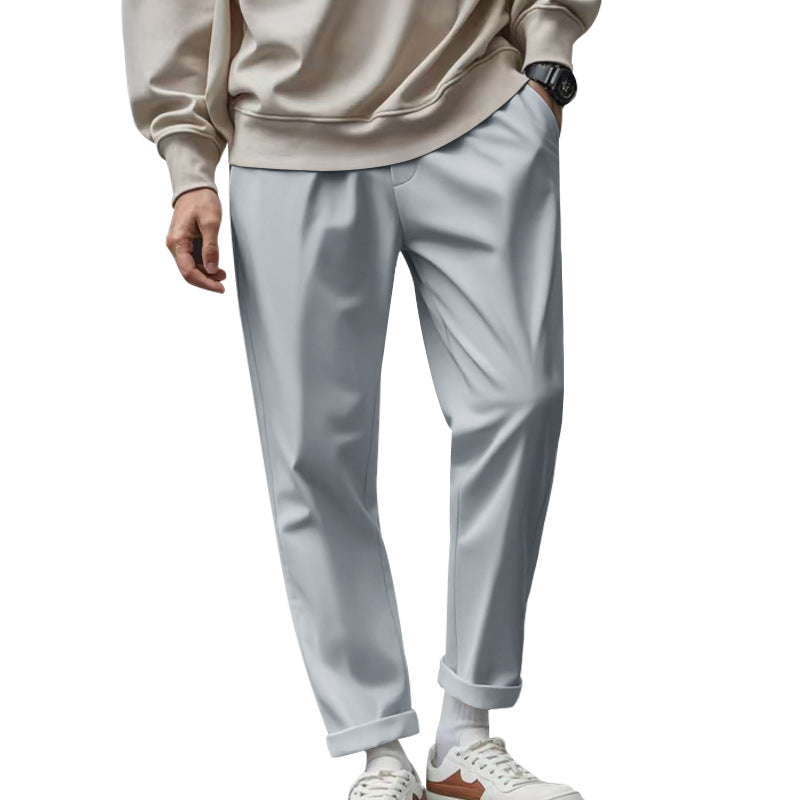 Men's stylish light gray sleek business trousers paired with a casual beige sweatshirt
